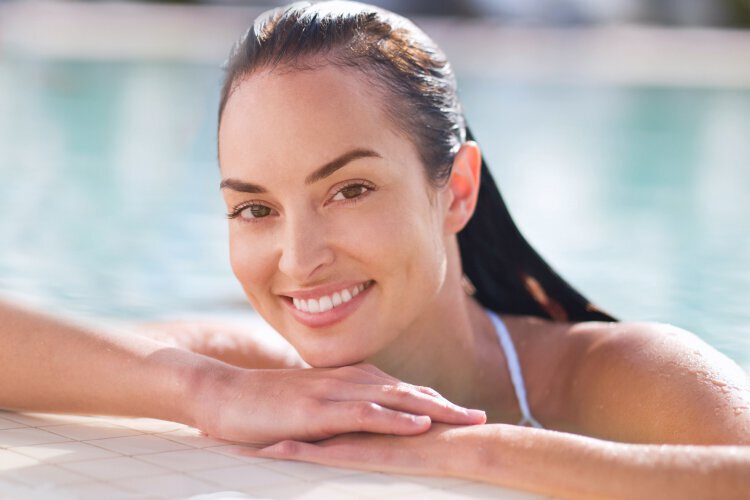 Skin Rejuvenation Feature - Smiling woman in pool
